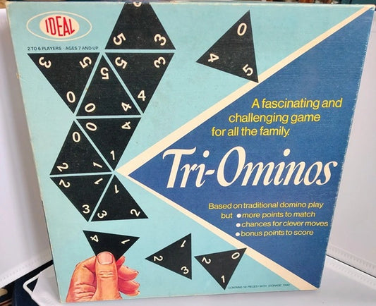 Tri-Ominos game box with black triangular pieces and blue background