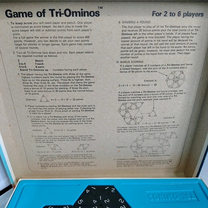Instructions for the Game of Tri-Ominos with text and diagrams on a beige background.