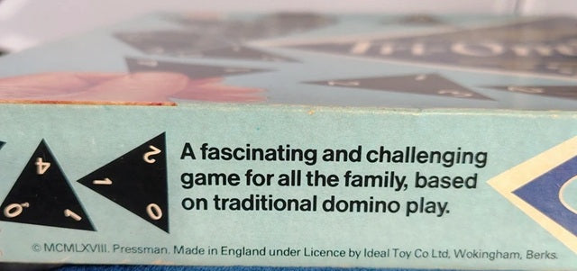 Close-up of a board game box with text about family-friendly gameplay.