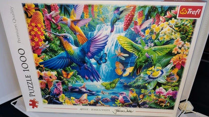 Colourful tropical scene with birds, butterflies and flowers surrounding a waterfall from a 1000 piece puzzle.