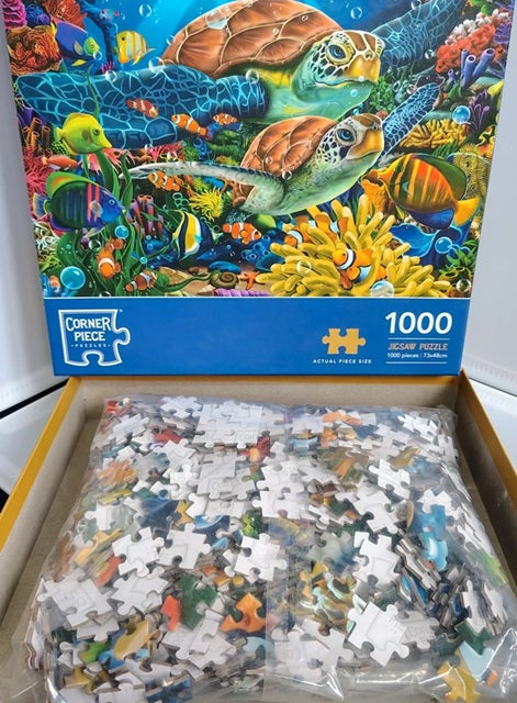 Jigsaw puzzle box with an underwater scene featuring turtles and fish, showing 1000 pieces.