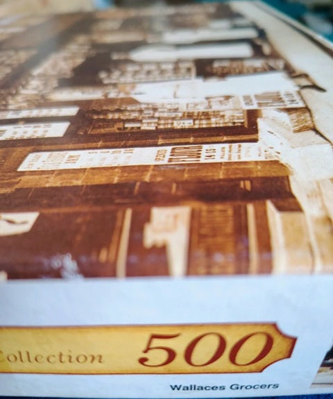 Close-up of a product packaging with 'Wallaces Grocers' branding and 'Collection 500' text.