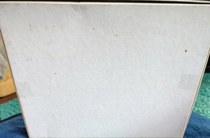 Close-up of a textured white surface with small brown spots