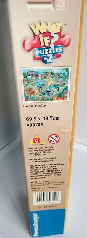 A boxed jigsaw puzzle package shown upright, with the back panel visible. The box reads 'What If? Puzzles 2' and 'Garden Open Day,' with dimensions '69.