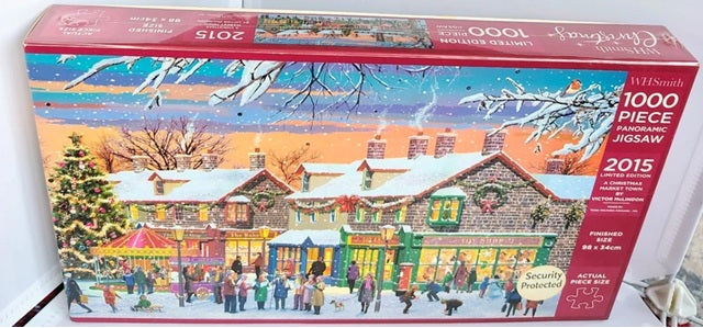 WH Smith A Christmas Market Town Jigsaw puzzle box with a winter village scene on a snowy day