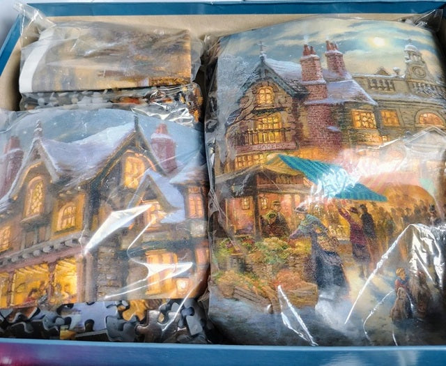 Packaged puzzle with a winter village scene in clear plastic wrap.