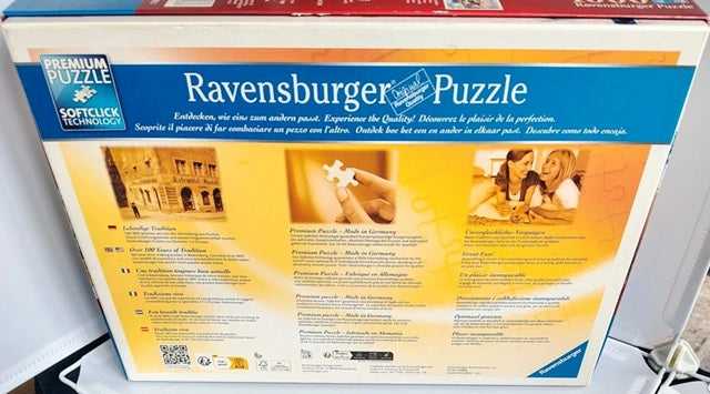 Ravensburger puzzle box with images of a family and a building on a white background
