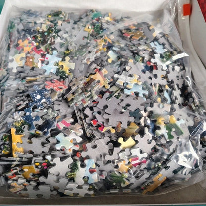 Jigsaw puzzle pieces in a box with various colors and designs.