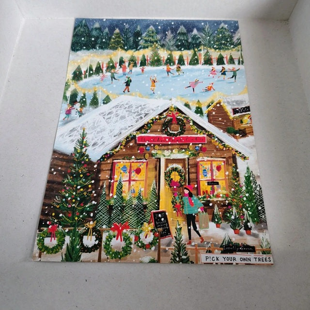 Decorative Christmas poster with a cabin scene and people skiing and ice skating.